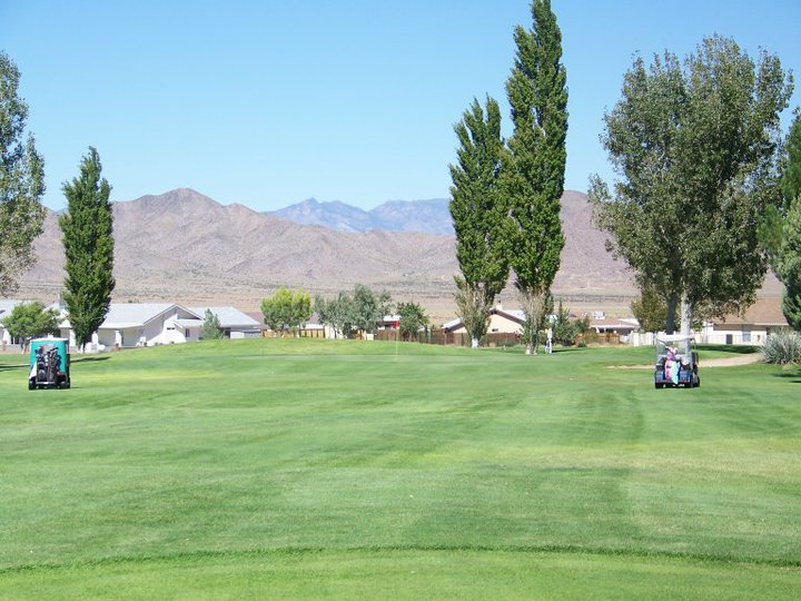 Course greens with mountain in background